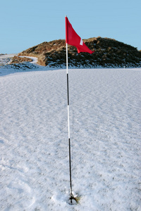 雪覆盖链接高尔夫球场红旗飘扬图片