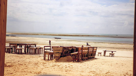 在海滩上的木制桌椅。家具闲逛