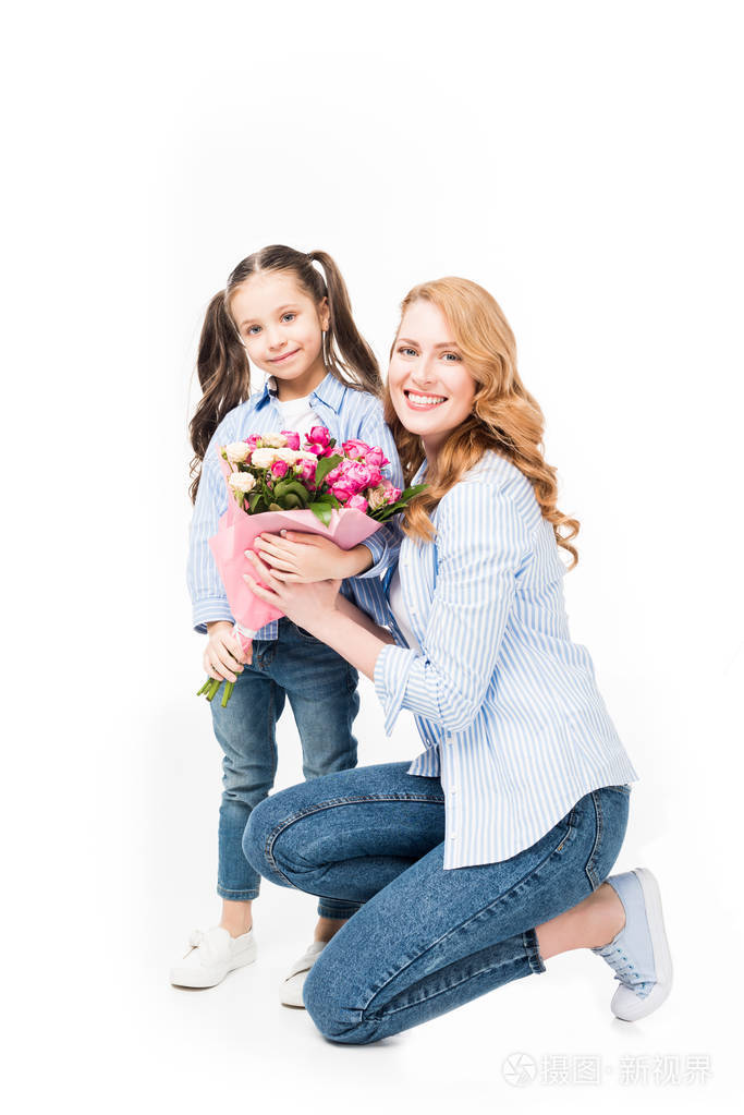 微笑的母亲和小女儿与花束的花朵隔离在白色, 母亲节的概念照片-正版