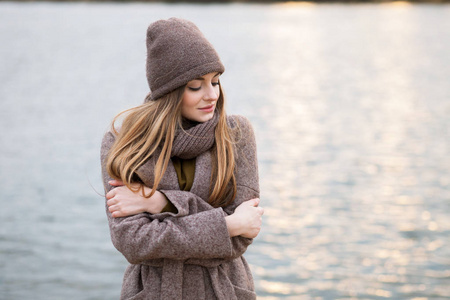 女孩在一个针织帽和围巾在秋季的性质。冷