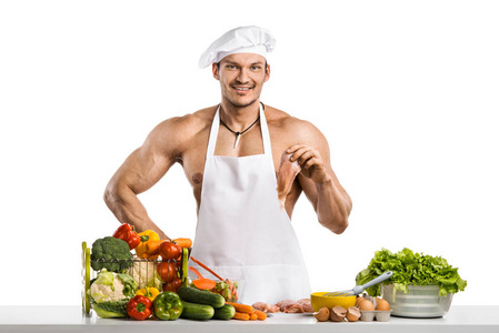 白色的无边帽的男子健美运动员布兰奇和厨师的防护围裙