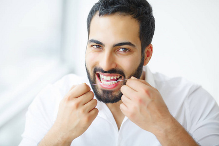 牙科保健。美丽微笑的人牙线健康的牙齿