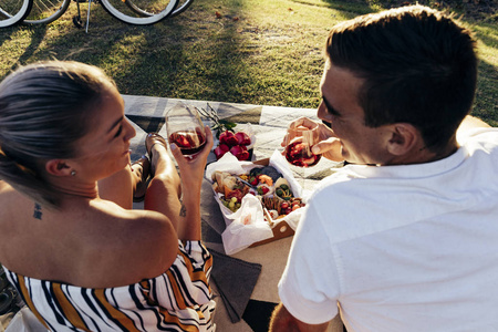 浪漫情侣在日落森林附近野餐图片