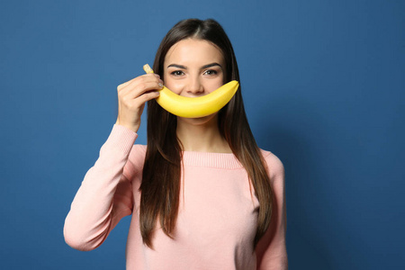 在颜色背景下的香蕉年轻女子滑稽肖像