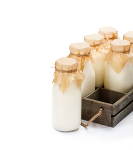 一个传统的玻璃牛奶瓶在木托盘上隔离