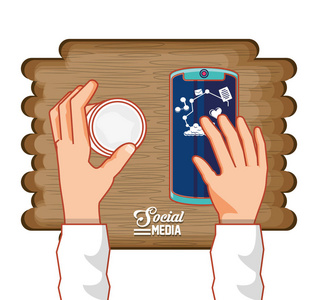 手与智能手机和社会媒体图标在木质背景