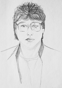 一个戴眼镜的年轻人的肖像.纸上铅笔画照片