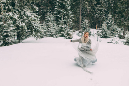 年轻漂亮的女孩等待她的情人在山的中间覆盖着积雪