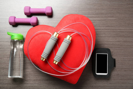 健身房的东西, 电话和红色的心在木质背景。心肺训练理念