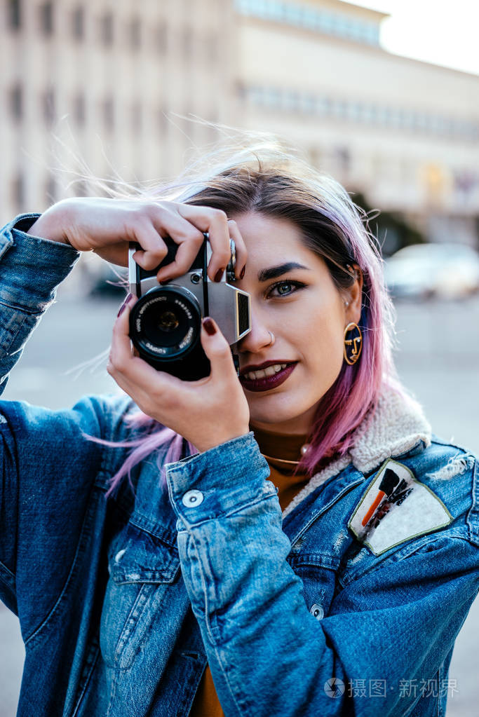 穿着牛仔夹克的摄影师女孩