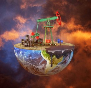 地球油泵生态概念.在穆迪背景下的一个切割行星上的油泵.的 c照片