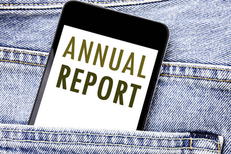 显示年度报告的手写公告文本。分析性能的商业概念手机手机, 手机放在男前牛仔裤口袋里