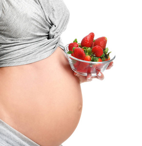 美丽的孕妇与大肚皮吃 strawberrie