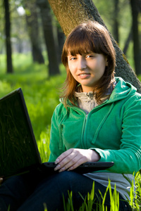 快乐的年轻女人用的笔记本电脑