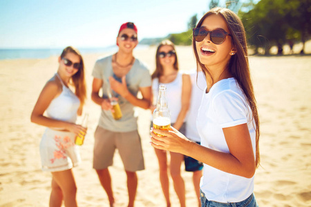 优秀青年群与啤酒在海滩闲逛的朋友.优秀的晴朗天气.美丽的身影.