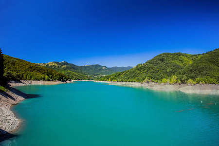 蓝色清澈的天空下的高山湖水图片