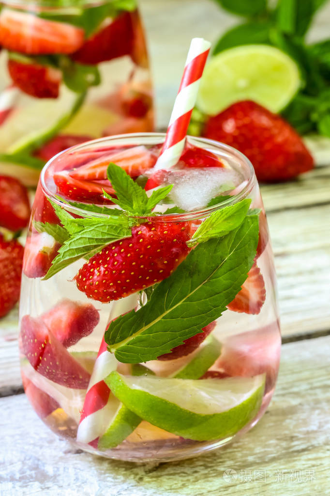 新鲜柠檬汁, 草莓, 石灰和薄荷在木质的背景.夏日清凉饮品