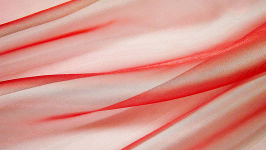 美丽的粉红色背景由浅色织物制成。抽象背景