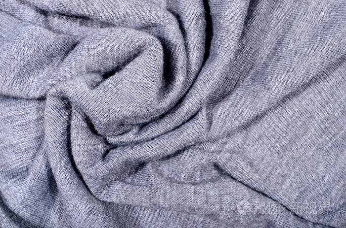 合上皱巴巴的针织羊毛织物质地.灰色编织毛衣为背景