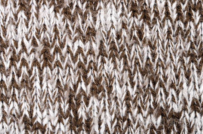 紧密的针织羊毛织物纹理.棕色和白色编织毛衣作为背景