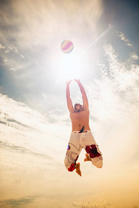 男子沙滩排球游戏玩家跳上热沙