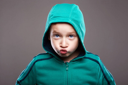 英俊有趣的孩子看着相机.滑稽的鬼脸情感孩子照片