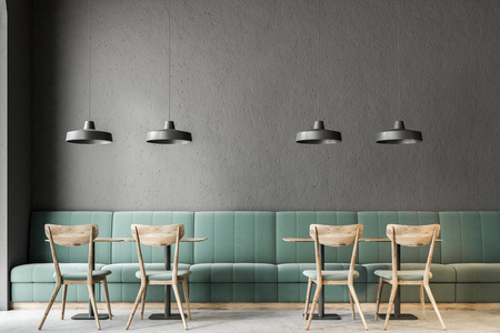 深灰色的墙壁咖啡馆内部与混凝土地板, 和木制桌椅。绿色沙发。3d 渲染模拟