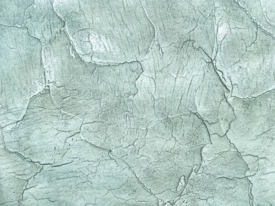 纹理装饰的浅绿色石膏仿旧的脱皮墙。陈旧的绿松石开裂的背景, 特写