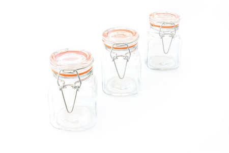 三迷你夹顶方形玻璃保持罐与线钳闭合在白色背景上
