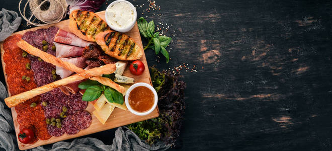切肉和冷藏小吃。意大利菜。在一个木质的背景。顶部视图。复制空间
