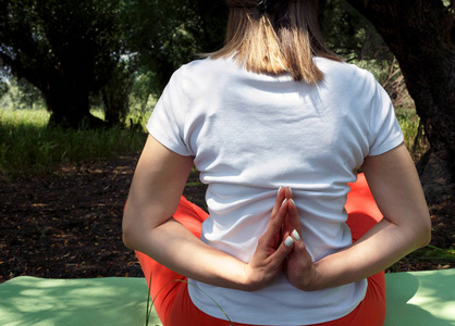 背部视图妇女冥想在瑜伽位置