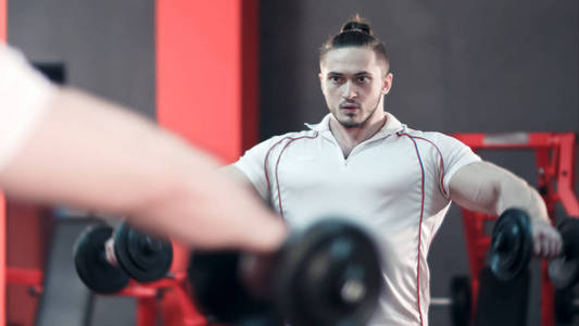 肌肉健美运动员在健身房锻炼哑铃