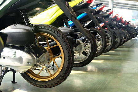 许多五颜六色的摩托车在陈列柜的后面出售