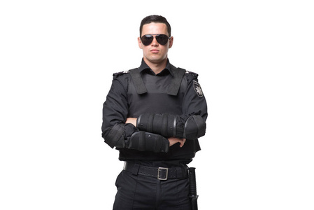 seriuse的警察戴着太阳镜和黑色制服,穿着白色背景的防弹衣.