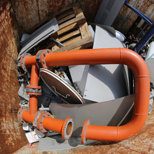 巨大的橙色管子在容器与许多用尽的材料