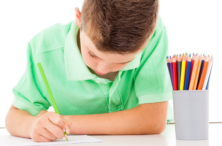 学校男孩在白色背景上用铅笔绘制