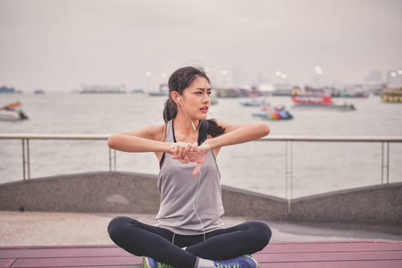 体育概念。美丽的女孩正在海滩上锻炼, 热身。美丽的女孩是愉快的锻炼