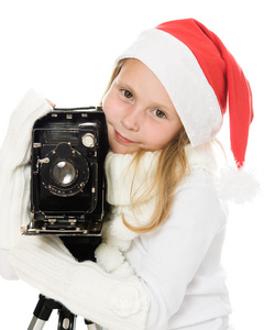 用老相机的圣诞服装的女孩