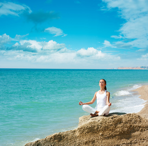 做瑜伽在海边的女人