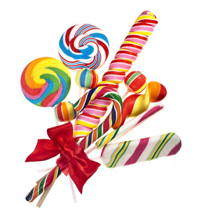 多彩蝴蝶结多彩棒棒糖红丝带蝴蝶结白色上孤立照片