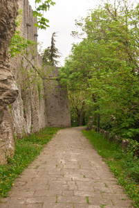 行人街与鹅卵石走在圣马力诺山的顶部旁边的围墙