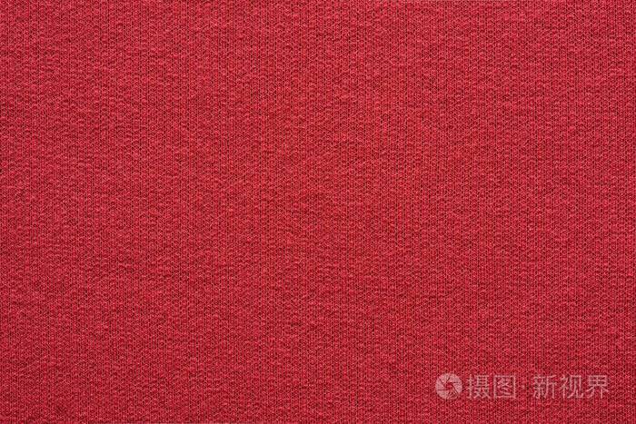 空白和干净的背景或墙纸与抽象针织纹理的织物或纺织材料的特写红颜色