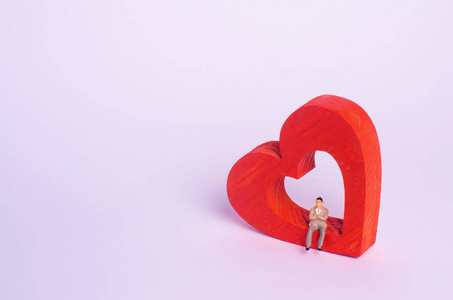 企业灵魂一个男人坐在一颗红色的心上等待着.