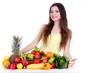 蔬菜和水果被隔绝在白色的表上的美丽女人