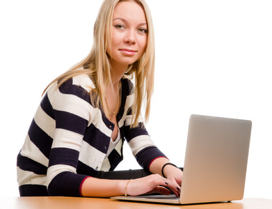 时尚年轻女人用一台笔记本电脑