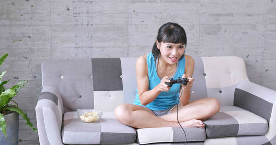 兴奋的女人在家里玩游戏照片