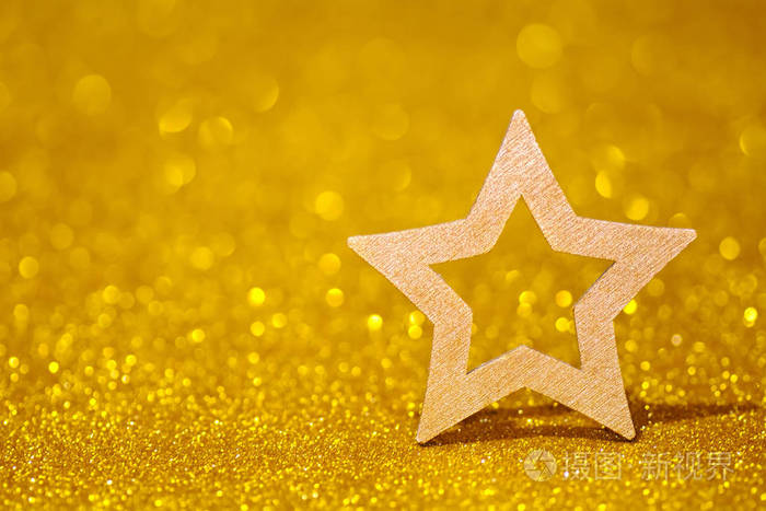 闪亮的星星在金色的光辉背景闪耀着星星形状的闪光