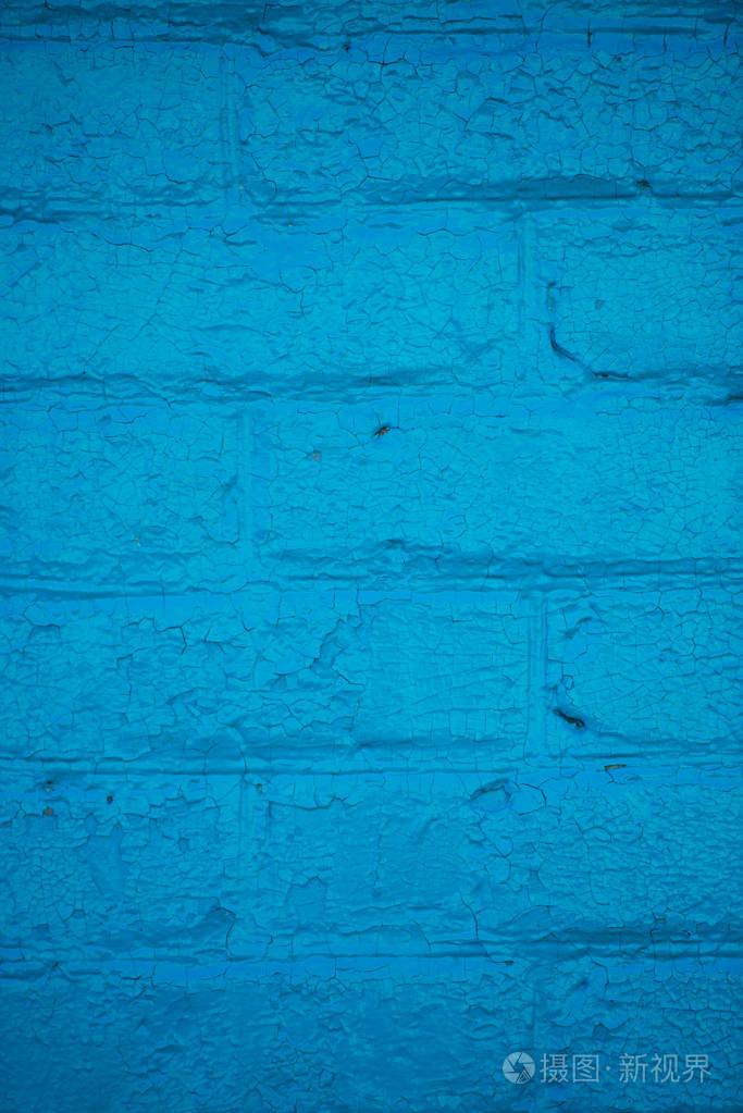 蓝色砖墙背景。彩绘砖的质地