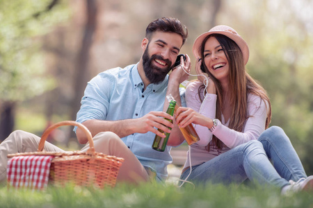 快乐的年轻夫妇在公园里野餐在晴朗的日子
