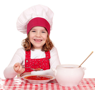 快乐小女孩厨师吃汤